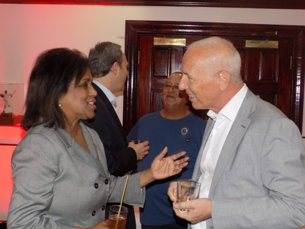 Minister of Trade and Industry Paula Gopee-Scoon, left, chats with a diplomat at Angostura's rum tasting at the Queen's Park Oval, Port of Spain on Monday night.