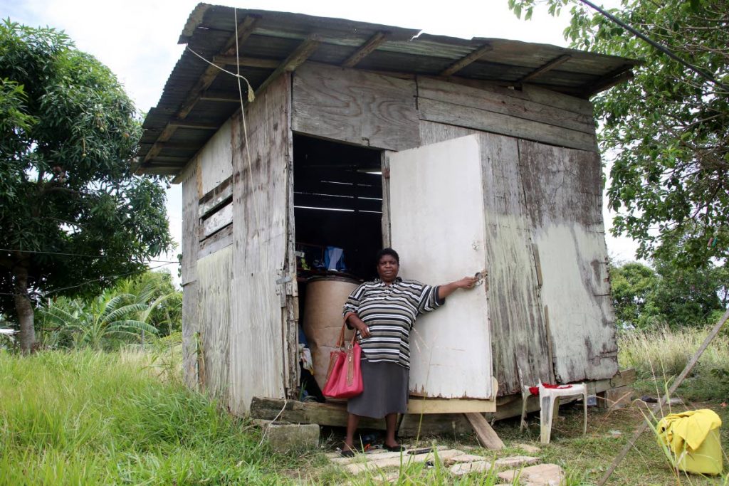 IN NEED OF HELP: Zeia Flemming of Maple Avenue, Pleasantville, San Fernando stands in front of the dilapidated shack, which she and  her 11-year-old son have been ordered to leave.  PHOTO BY VASHTI SINGH