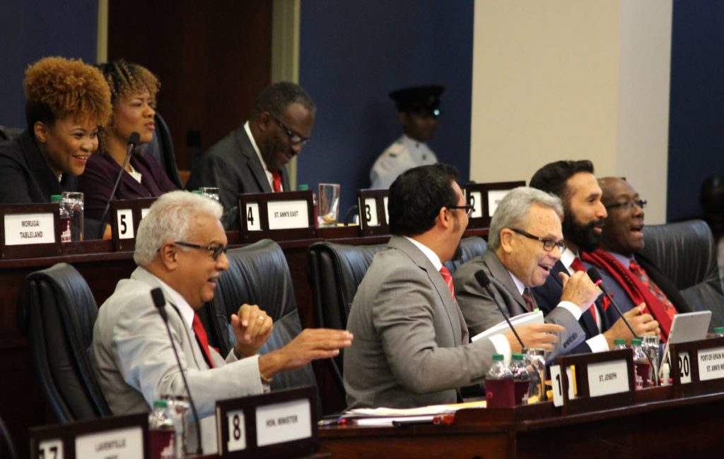 TAKE DAT!:Mirthful government MPs, from right, Prime Minister Dr Keith Rowley, Attorney General Faris Al Rawi, Finance Minister Colm Imbert and Health Minister Terrence Deyalsingh poke fun at the
Opposition yesterday in Parliament.