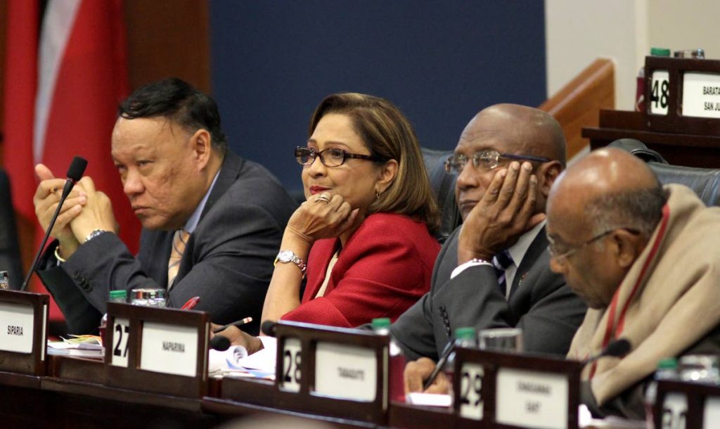 UNIMPRESSED:Opposition Leader Kamla Persad-Bissessar and fellow MPs David Lee, left, and Rodney Charles were clearly unimpressed with Government⁳ mid-year Budget review delivered by Finance Minister Colm Imbert in Parliament yesterday. PHOTO BY ROGER JACOB