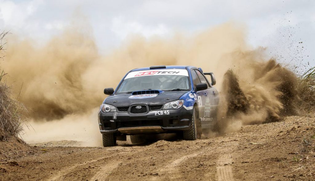 Stuart Johnson and co-driver Wayne Persad on their way to victory in Sunday’s rally event in Couva.