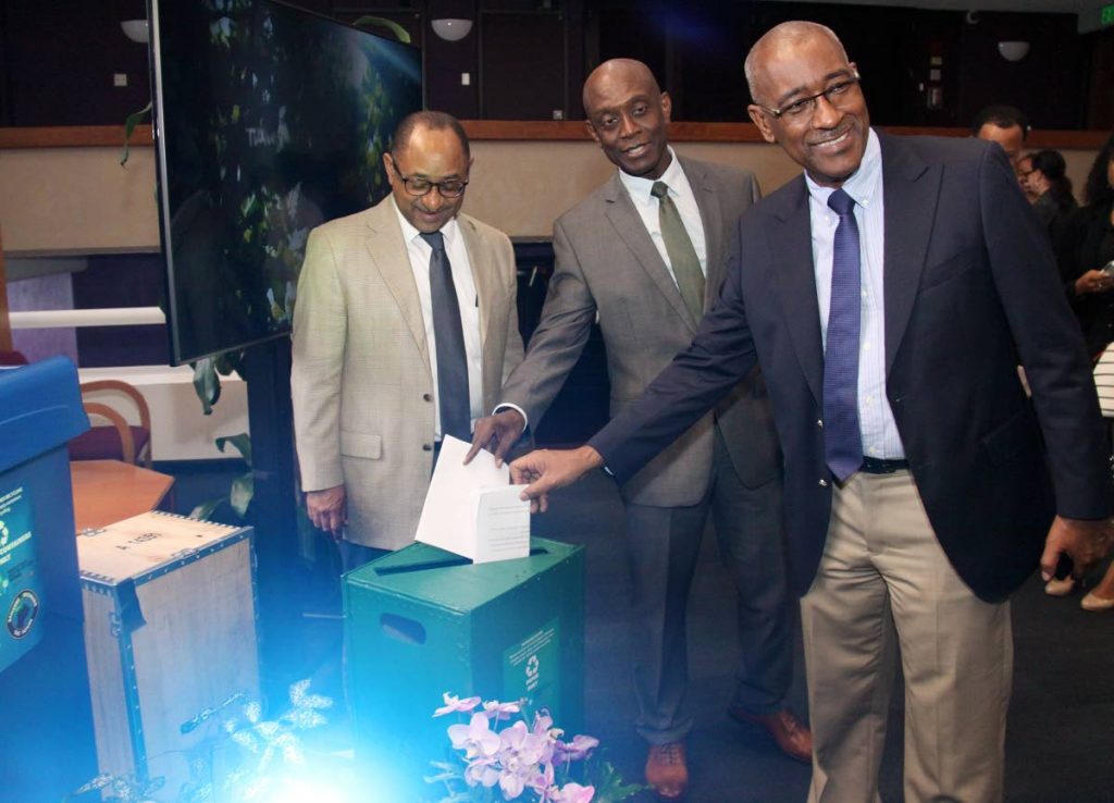 EMA Managing Director Hayden Romano, Central Bank Governor Dr. Alvin Hilare and Minister of Public Utilities Robert Le Hunte, view recycle bins at the launch of the WRAP logo, Central Bank, Port of Spain.

PHOTO:ANGELO M. MARCELLE