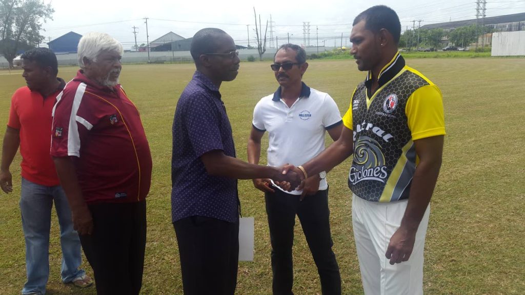 Acting director of sport at the Ministry of Sport and Youth Affairs Patrice Charles meets Central Zone 
captain Denesh Ramdin.