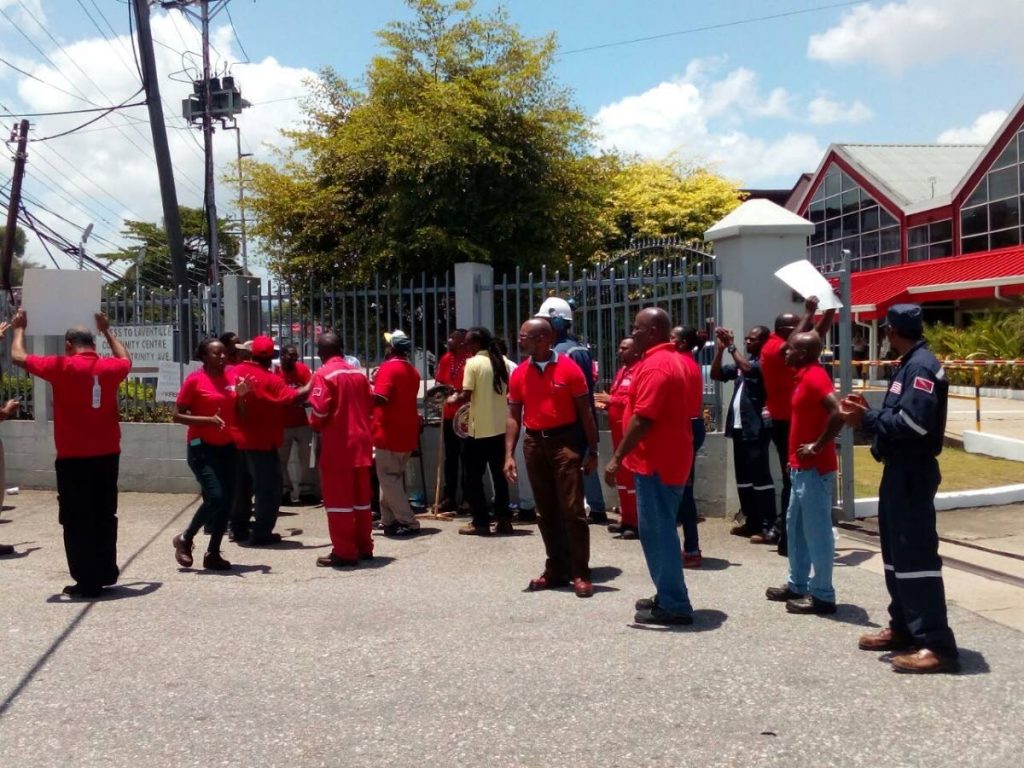Angostura workers march on Friday outside the company’s compound, Eastern Main Road, 
Port of Spain.  PHOTO COURTESY SWWTU