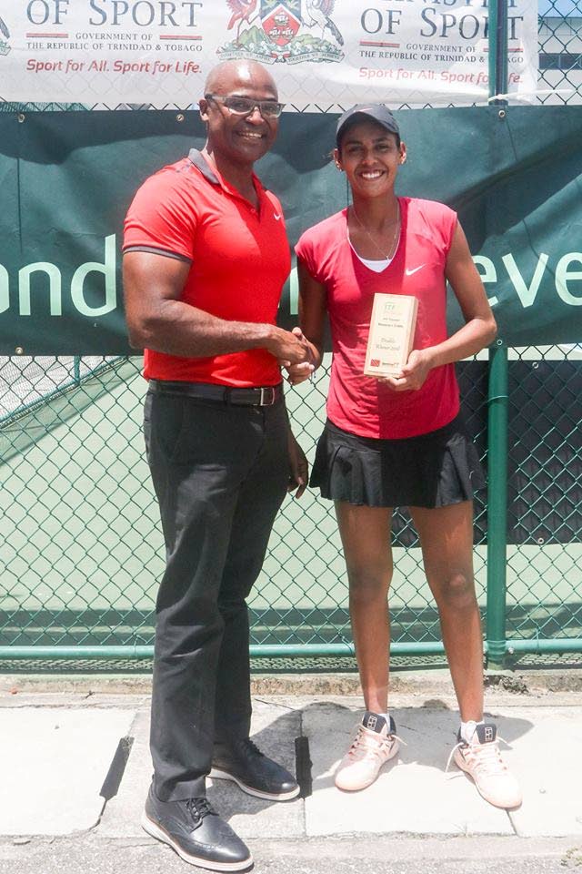 Maria Portillo Ramirez (right) receives her plaque, as the singles champion, from TT Tennis Association president Hayden Mitchell at the National Racquet Centre, Tacarigua yesterday. PHOTO COURTESY TT TENNIS ASSOCIATION’S FACEBOOK PAGE