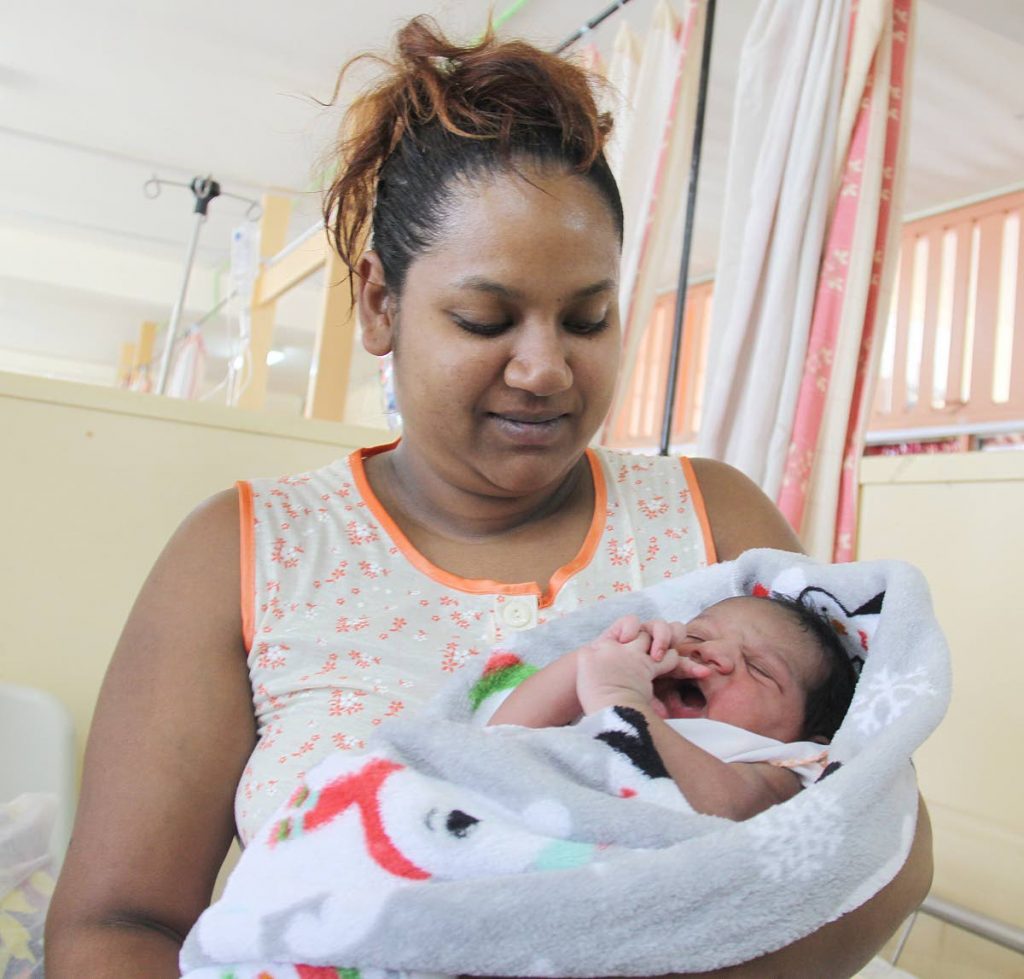 PROUD MOTHER: Sarah Sookdeo admires her daughter Caylee hours after she was born at the Port of Spain General Hospital yesterday.  PHOTOS BY ANGELO M. MARCELLE
