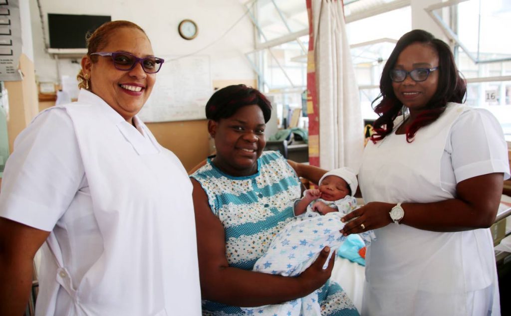 MY BOY: Nurses Marlene Ramnarine (left) and Paula Constance congratulate new mother 
Afi Bertrand-Carter on the birth of her son Christian Elijah Francis Carter at the San Fernando General 
Hospital yesterday.