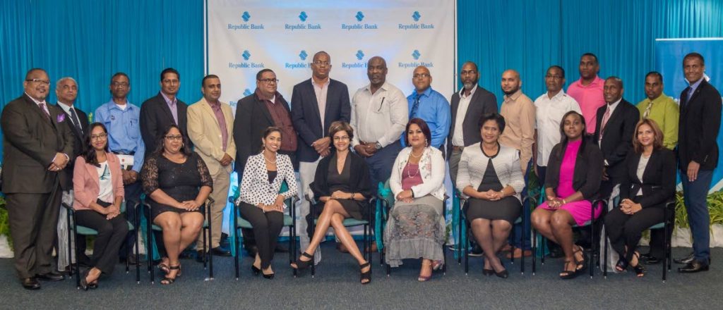 Republic Bank Ltd's (RBL) Managing Director, Nigel Baptiste, poses for photos with graduates of the Republic Bank ActionCLUB workshop at their May 9 graduation ceremony, RBL head office, Park Street, Port of Spain. PHOTO COURTESY RBL.