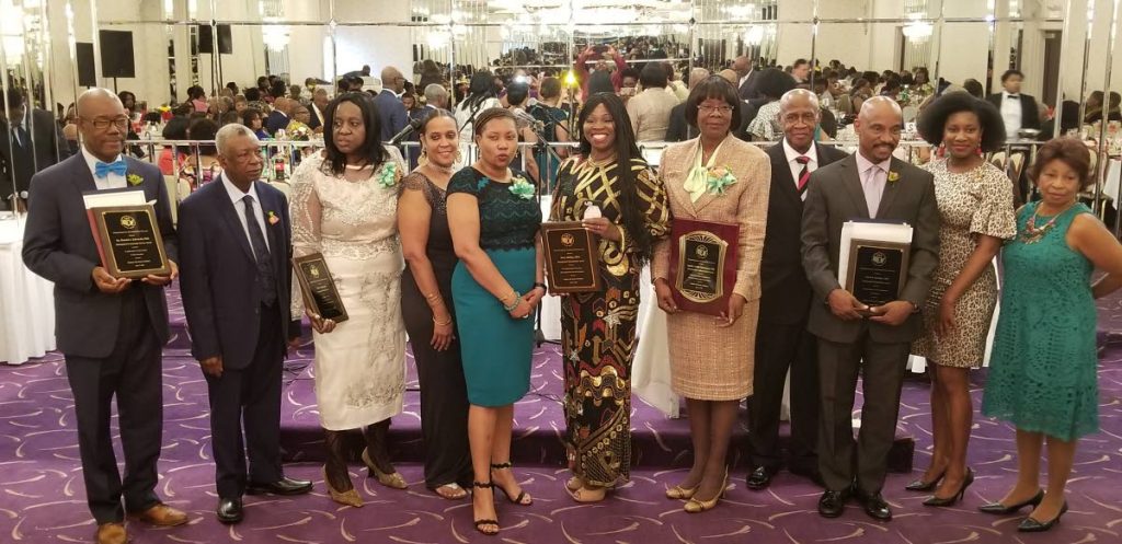 Health Secretary Dr Agatha Carrington, fifth from right, displays her awards as she poses for a photo with other awardees at the 24th Annual Awards Luncheon the Trinbago Progressive Association of the USA Inc on May 6 in New York. PHOTO BY THA