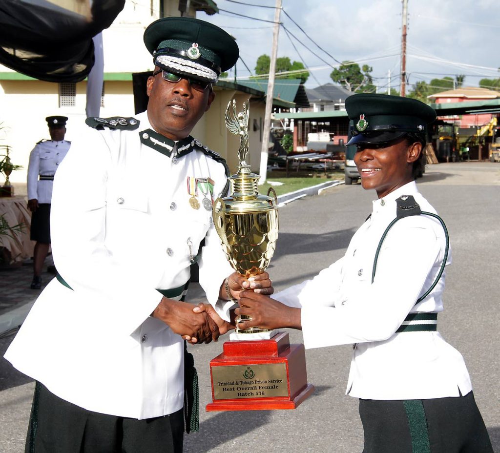 Charisma Coombs-Ince receives an award for being the top Female Recruit from Prisons Commissioner Gerard Wilson.