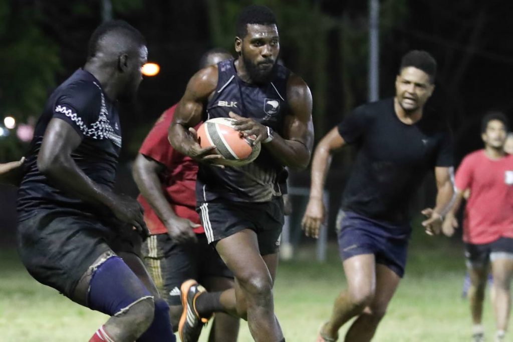 Trinidad and Tobago’s James Phillip advances with the ball during a national rugby training session recently at President’s Grounds, St. Ann’s. TT are preparing for Rugby Americas North Championships starting this weekend.