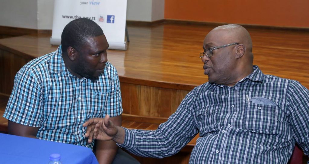 Chief Secretary Kelvin Charles, right, chats with Steve Peterkin, a teacher at the Signal Hill Government primary, following the Tobago House of Assembly’s One-on-One meeting at the Lambeau Multipurpose Facility on Tuesday night.