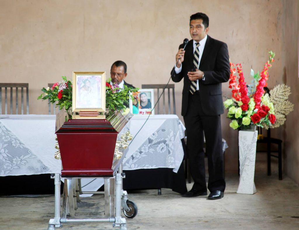 WORDS OF COMFORT: Pastor Kevin Mohammed addresses mourners at the funreral for Anita Ramdath who died when a fire partially destroyed her family’s home in Princes Town on Tuesday.