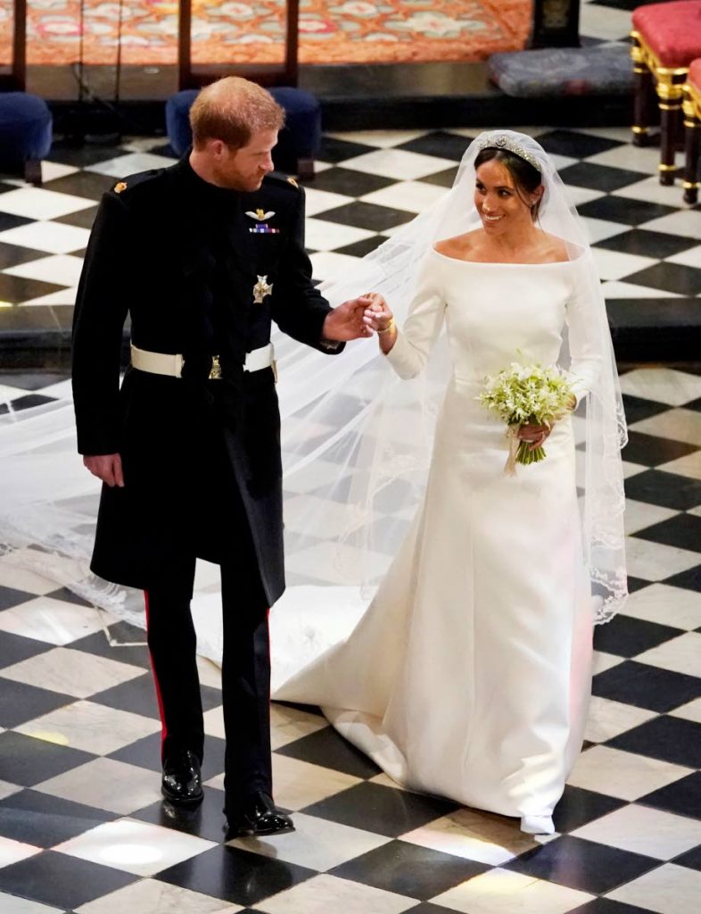 The dress: Prince Harry and Meghan Markle leave St George’s Chapel, Windsor Castle after their wedding yesterday. Markle wore a dress by British couture designer Clare Waight Keller for French fashion house Givenchy. AP Photos
