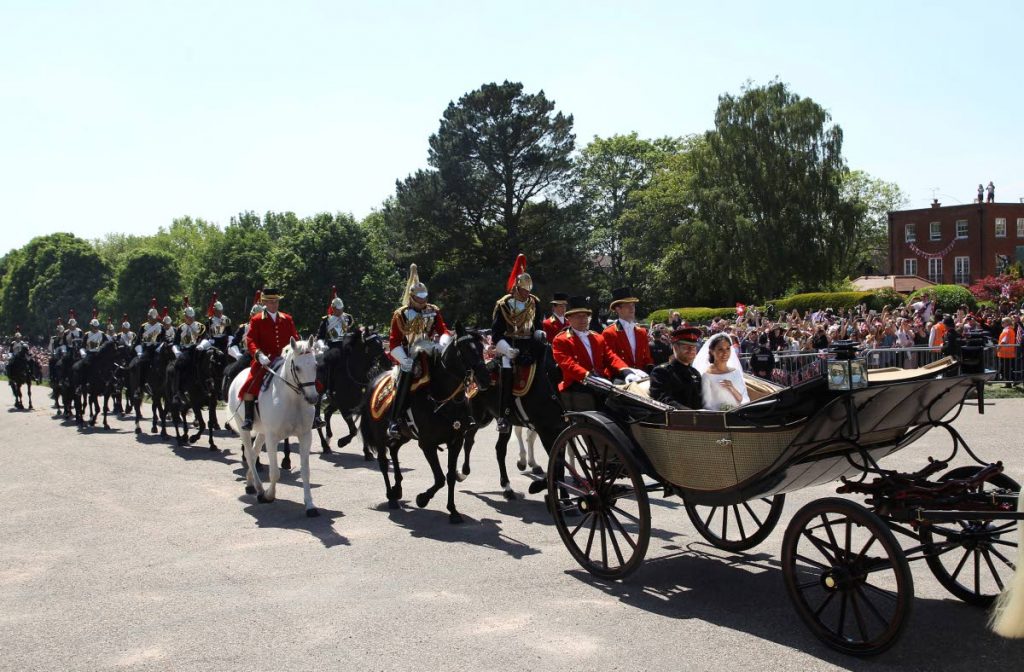 Prince Harry and his wife Meghan Markle ride a horse-drawn carriage, after their wedding ceremony at St George’s Chapel in Windsor, near London, England yesterday.