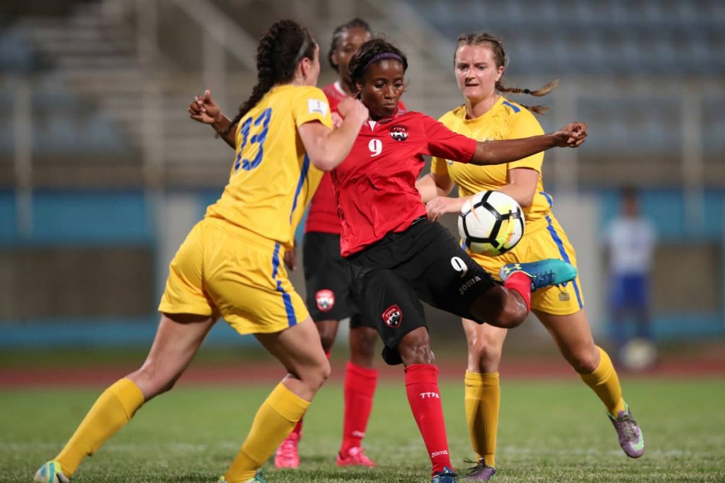 TT's Mariah Shade shoots to score against the US Virgin Islands in a 10-0 victory at the Ato Boldon Stadium, Couva, Saturday night. 