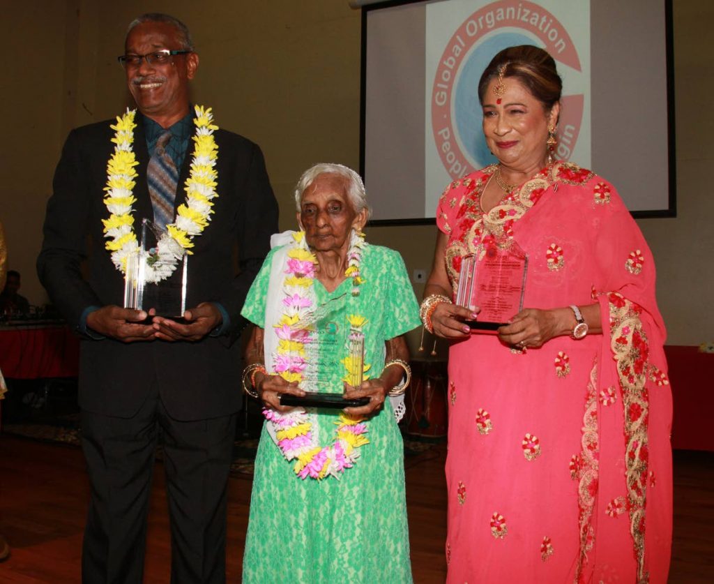 Former school teacher Victor Edward, 100-year-old Jassoo Sookram and Opposition Leader Kamla Persad-Bissessar were honoured at GOPIO’s Indian Arrival Day dinner at the Chagauanas Borough Corporation Auditorium, on Saturday.