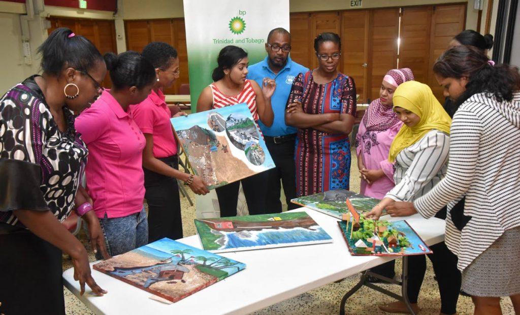 Arvolon Wilson Smith (third from left), President and Founder of The Black Deer Foundation, assists Vanissa Mohammed (fourth from left), art judge for the 2018 BP Trinidad and Tobago Environmental Awareness Competition, to explain what is expected for artwork submissions.