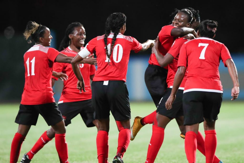National footballer Karyn Forbes, second from right, is congratulated by teammates after scoring in Saturday’s 10-0 rout of US Virgin Islands in the CONCACAF Women’s World Cup Qualifier, Caribbean Round, at the Ato Boldon Stadium, Couva.