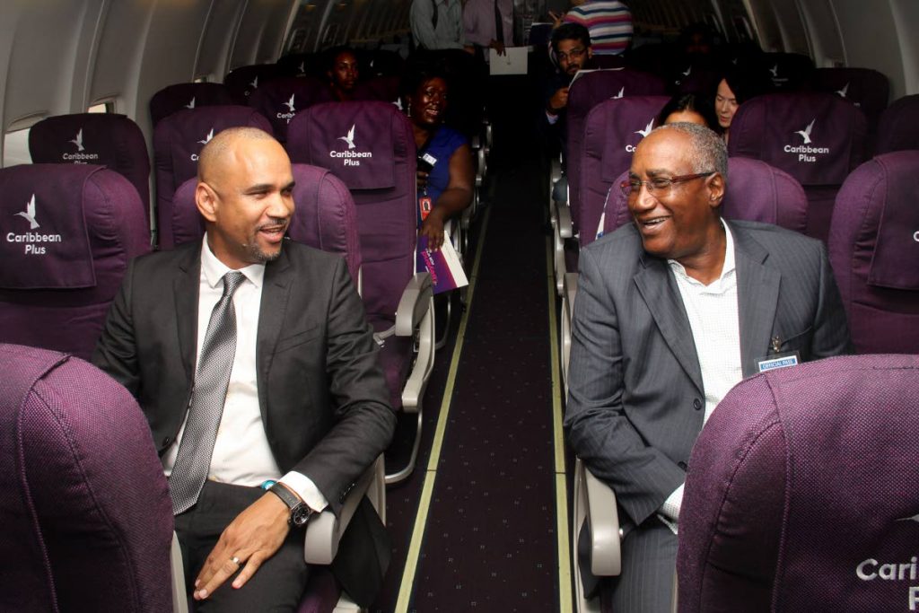Caribbean Airlines CEO Garvin Medera, left, and Airports Authority chairman Keith Thomas relax in the airline’s Premium Economy seats at Hangar 10, Piarco International Airport on Monday. PHOTO BY ANGELO MARCELLE