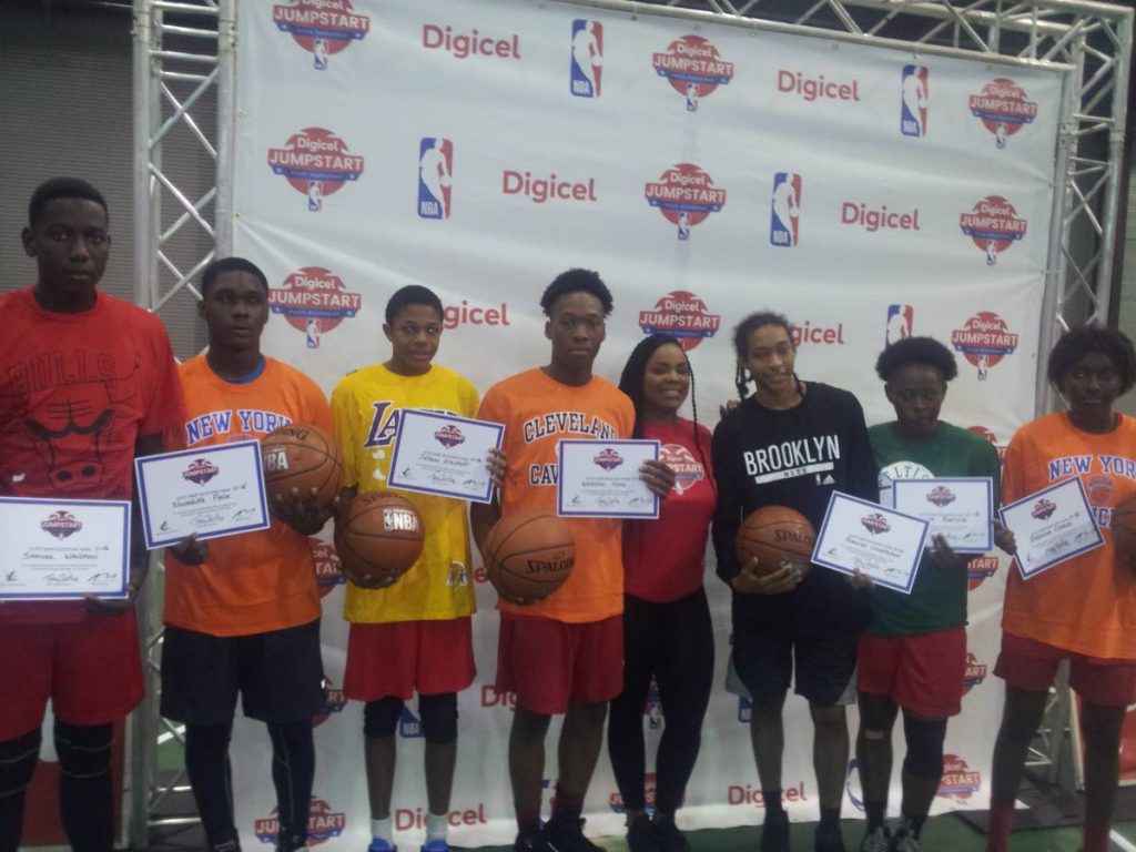 Roshawn Campbell, marketing executive at Digicel, fourth from right, with the seven basketballers who were selected for an Elite Camp following the conclusion of the Digicel/NBA Jumpstart Clinic at the Centre of Excellence, Macoya, on Sunday.