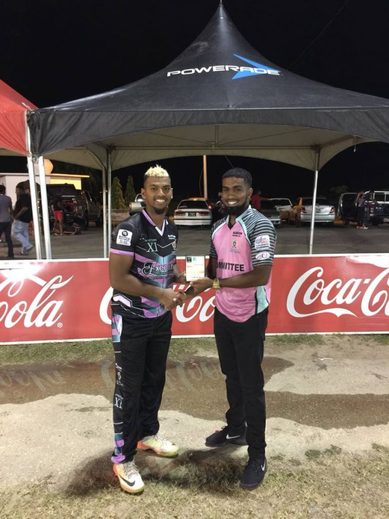 Mystery XI’s Nicholas Pooran, left, collects his Man of the Match award after beating Dream Team in the Central Super League T20 recently.