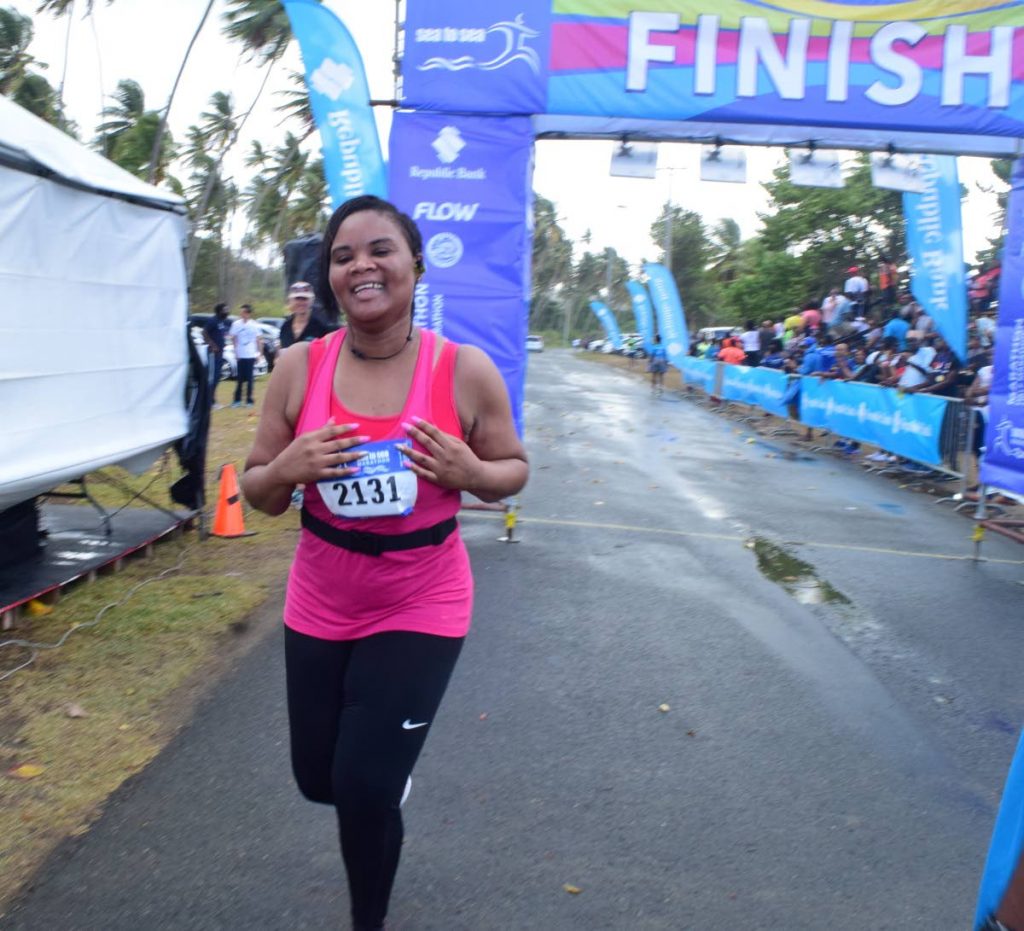Sports Minister Shamfa Cudjoe finishes the third annual Sea to Sea half-marathon in a time of three hours and 31 
minutes, on Saturday.