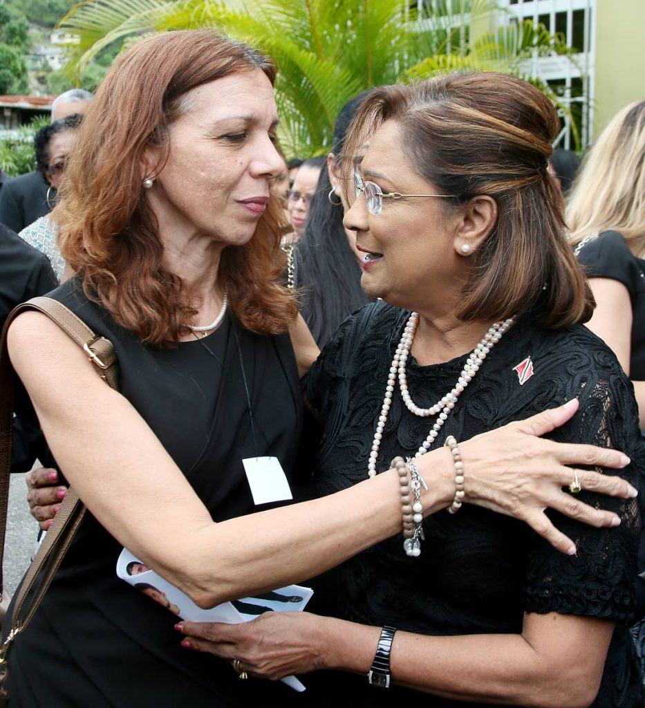 SUPPORT: Opposition Leader Kamla Persad-Bissessar offers support to Alison Mohammed, the mother of Uber driver Christopher Mohammed, who was shot dead on Thursday last week, at his funeral held at the St Anthony’s RC Church, Petit Valley yesterday.    PHOTO BY AZLAN MOHAMMED
