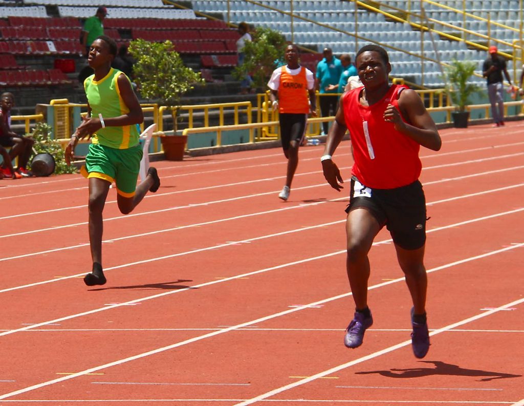 Jordan Noel,right, running for Port of Spain, takes gold in the Boys U13 400m, yesterday during action in the Atlantic Primary Schools Track and Field Championships.