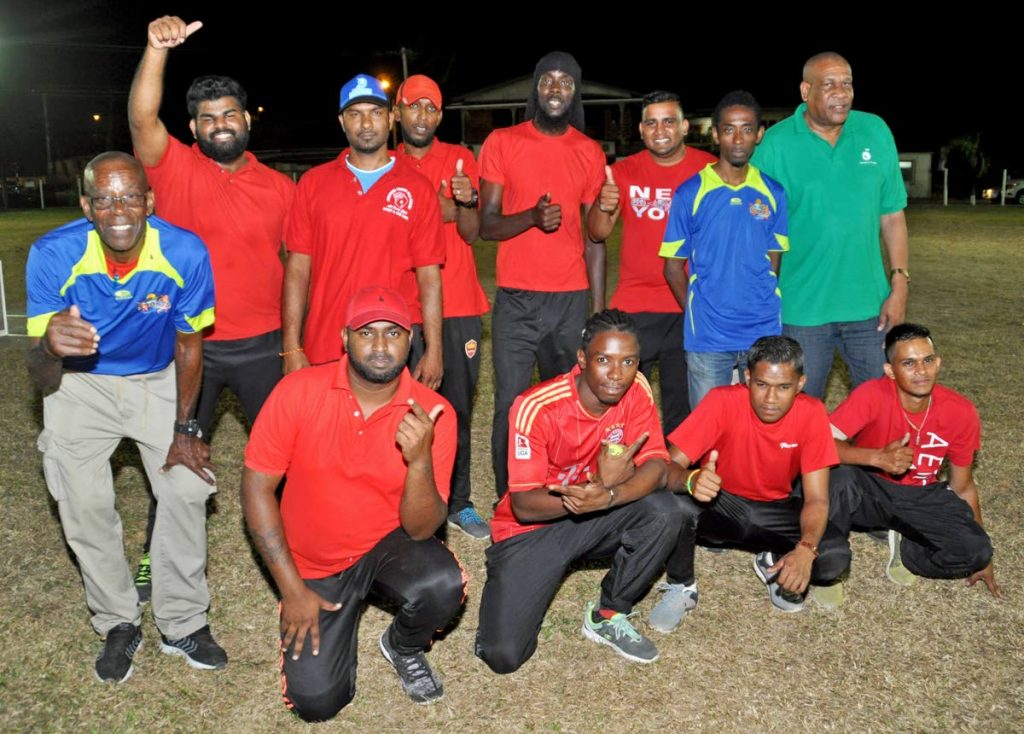 Bartholomew Lynch (left), president, All Mayaro Sports Foundation; Matthew Pierre (back row- right), Community Liaison Officer, BP TT; and Jameson Rigues (back row- second from right), corporate secretary, AMSF, join the Late Boys cricket team, who emerged as men’s round robin champions at the exciting launch of the 2018 BPTT Mayaro Night Cricket Windball competition.