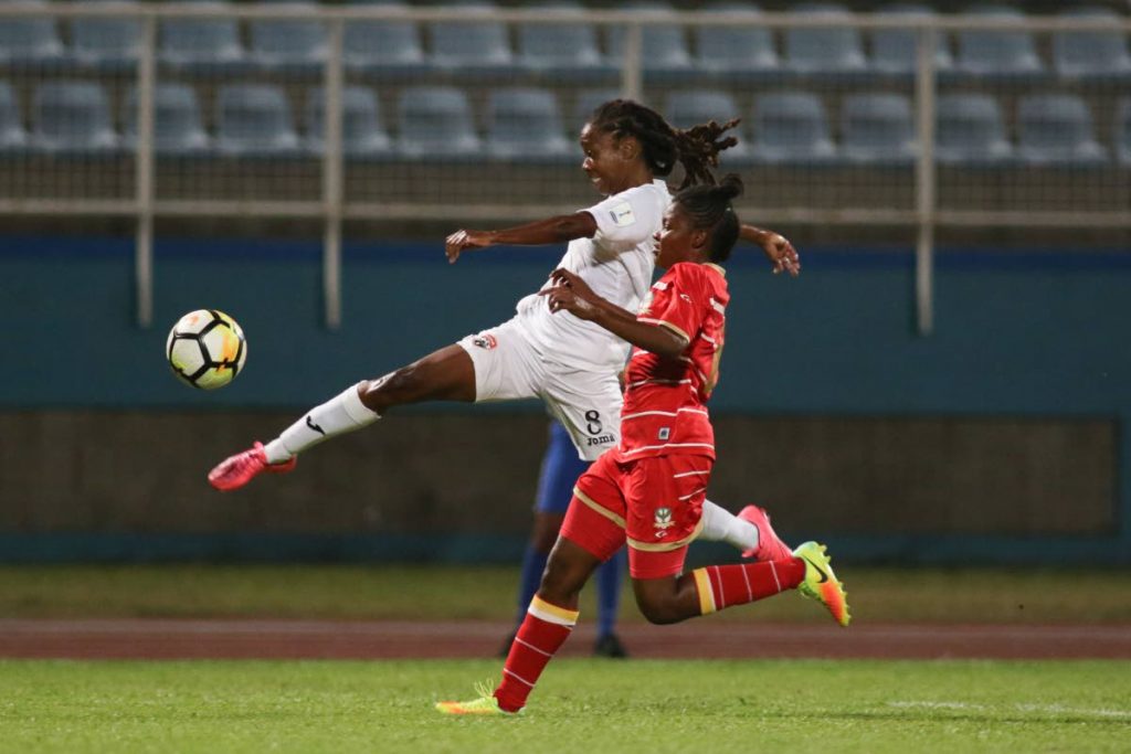 TT’s Patrice Superville goes airborne to make a cross against St Kitts and Nevis in a CONCACAF Women’s Championship Qualification match at the Ato Boldon Stadium, Couva, yesterday.