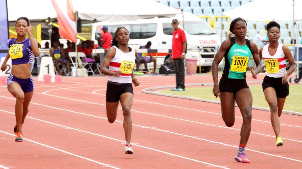 Shaniqua Bascombe, 2nd right, from Cougars Club, races to victory in the Girls U17 100m heat in a time of 11.75 seconds, yesterday, during action in the 30th Annual Hampton Games, at the Hasely 
Crawford Stadium, Port of Spain.