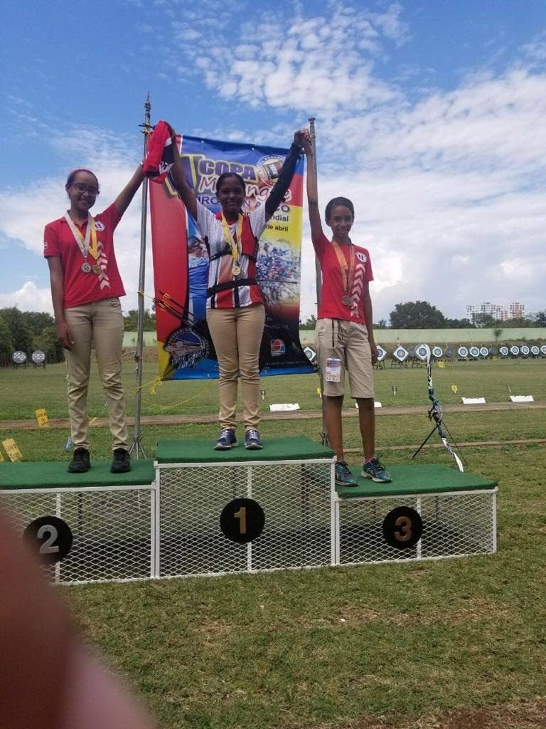 Mariah Khan (centre) captures gold in archery.