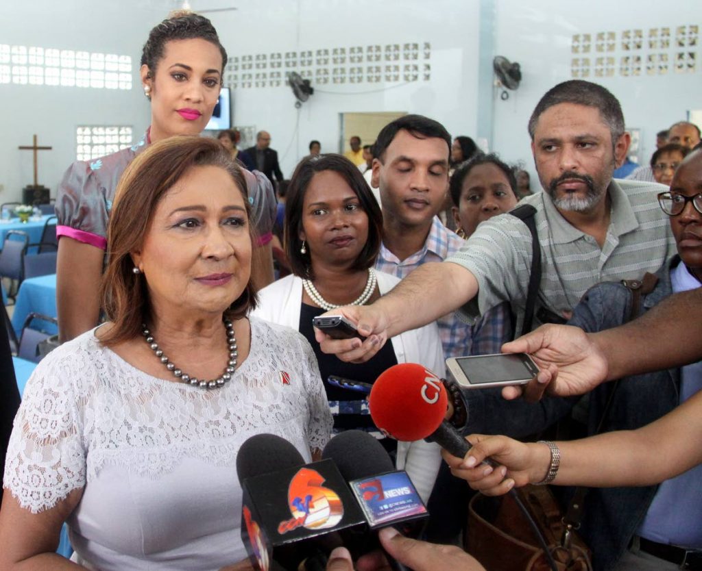 FACE THE MEDIA: Opposition Leader Kamla Persad-Bissessar speaks with reporters yesterday following a service at the St Joseph 
Presbyterian Church.