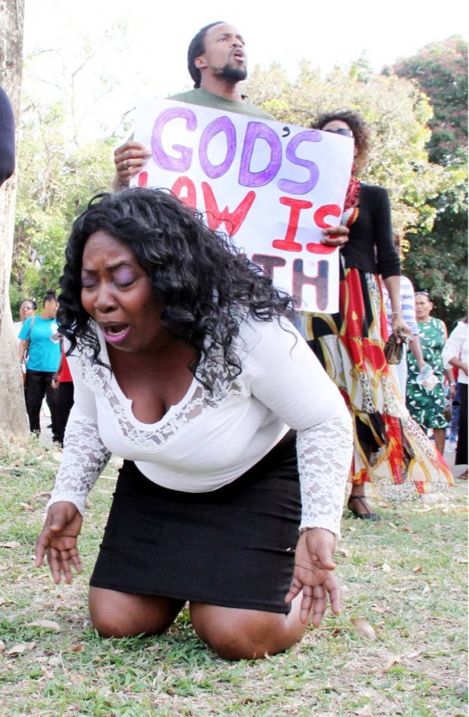 HEAR MY PRAYERS: 
A woman goes down on her knees in prayer at Woodford Square in Port of Spain 
yesterday during a rally in favour of keeping the anti-buggery law. PHOTO BY SUREASH CHOLAI