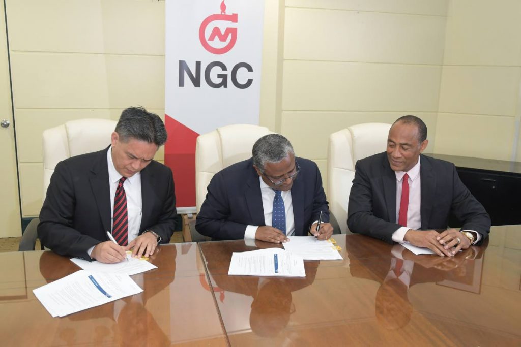 NGC President, Mark Loquan (from left); ENH Chairman and CEO, Dr Omar Mithá and NGC Chairman, Gerry C Brooks sign the Technical Services Agreement at NGC Head Offices. PHOTOS COURTESY NGC