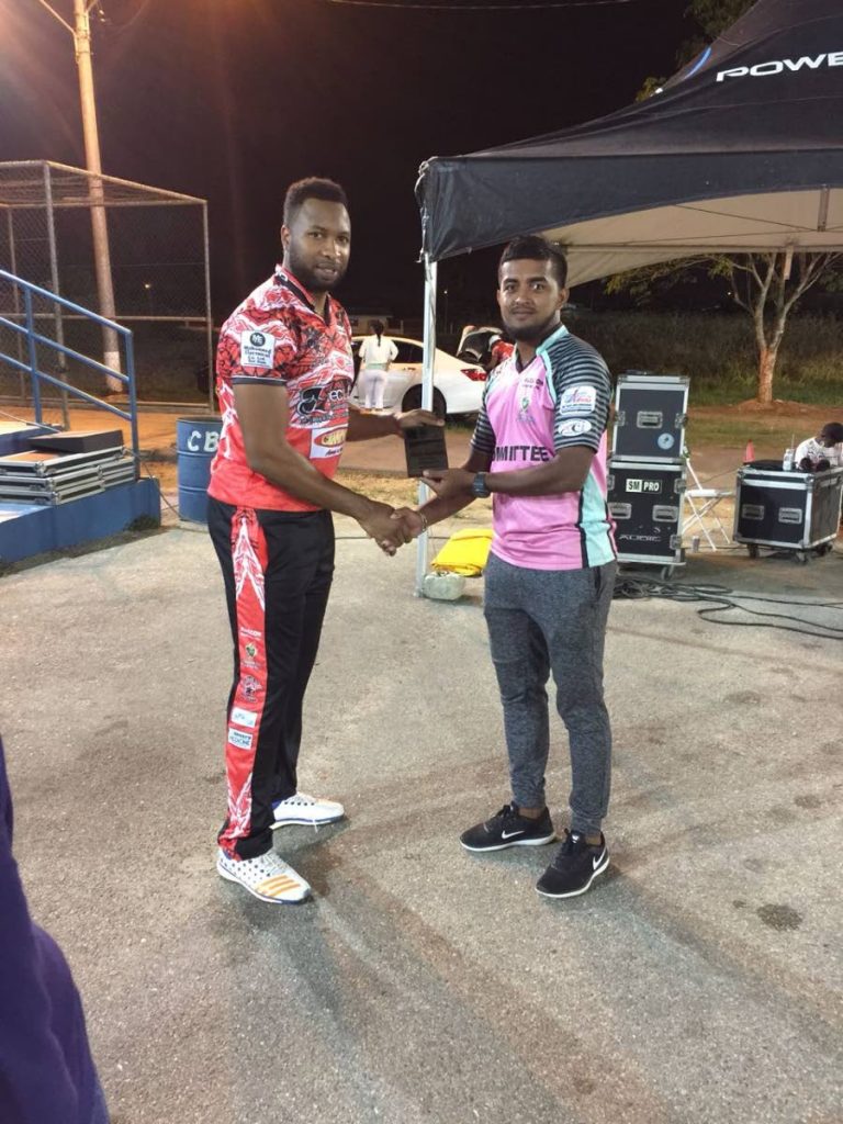 Bamboo All-Stars’ Kieron Pollard, left, receives his Man of the Match award from Vikash Mohan after leading his team to victory in the Central Super League T20.