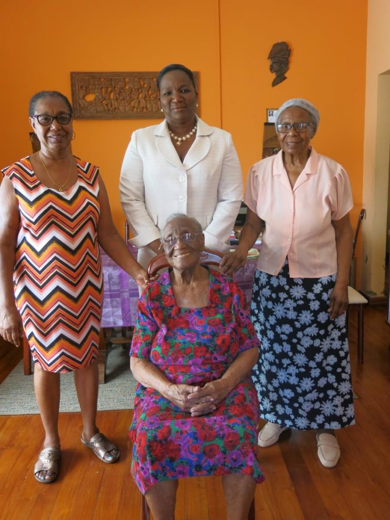 Woodbrook centenarian Ida Berry, seated, is surrounded by Minister Crichlow-Cockburn, centre, and relatives.