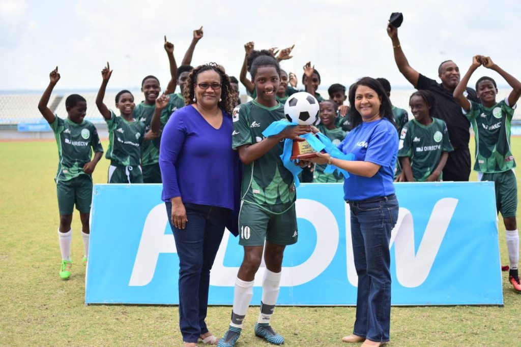 Flow senior marketing manager Ria Maharaj, front right, and TT Pro League CEO Julia Baptiste, front left, present W Connection Under-14 captain Molik Khan, centre, with the Flow Youth Pro League Cup U-14 trophy at Larry Gomes Stadium in Arima on Sunday.