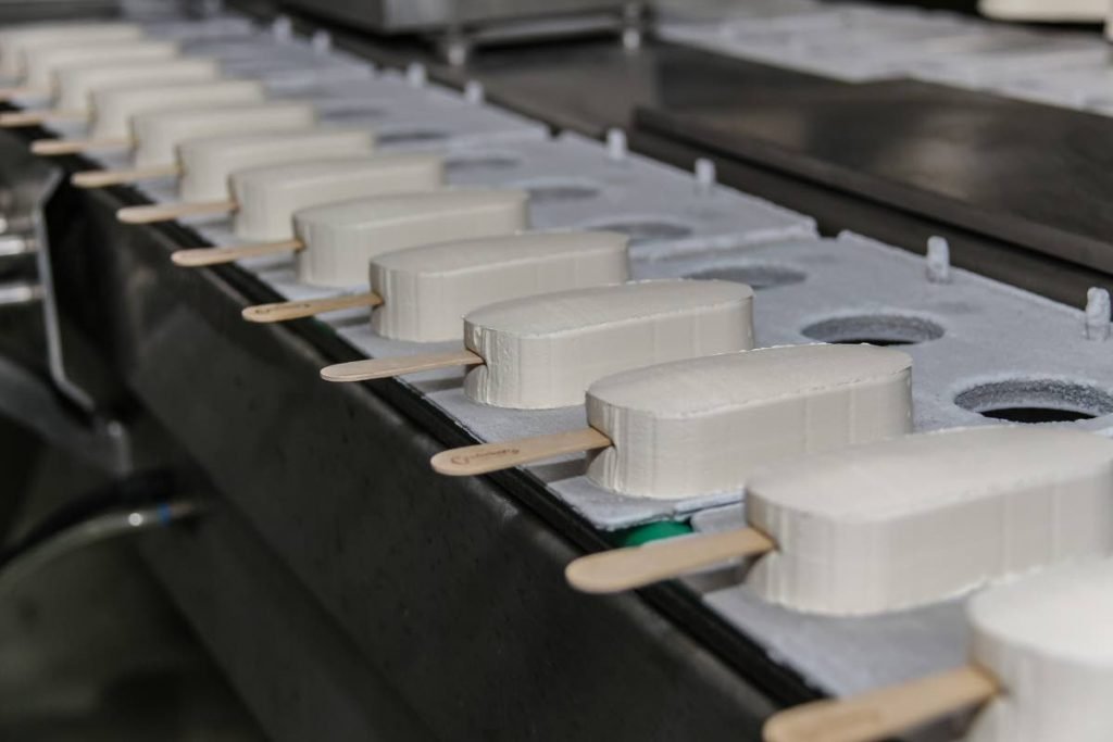 Ice cream lollies on the way to be packaged at the Creamery Novelties Limited factory. Photo by Jeff K Mayers