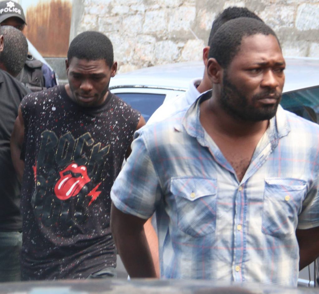 CHARGED: Josiah Duntin (left) and his brother Rutendo are escorted to the San Fernando Magistrates’ 
Court on Tuesday.