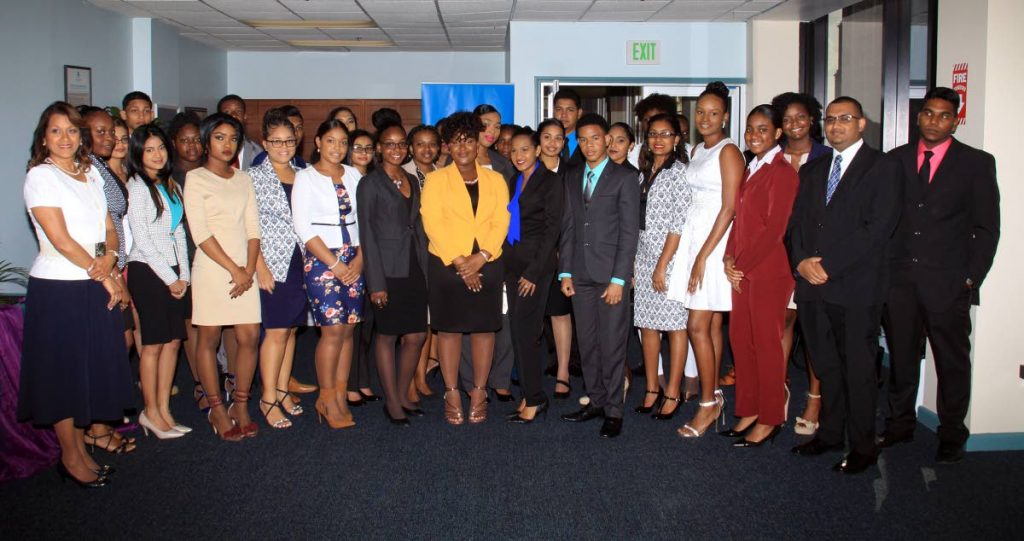 Republic Bank Youth Link Apprenticeship Programme Valedictorians, Karissa Lewis and Tyreece Regis, 5th and 7th from left respectively, along with all the other participants, pose for a photo up at the programme's graduation ceremony, Republic House, Park Street, Port of Spain. Left is  Group Human Resources General Manager, Anna-Maria Garcia-Brooks, Republic House, Park Street, Port of Spain. PHOTO BY ANGELO M. MARCELLE
29-05-2018