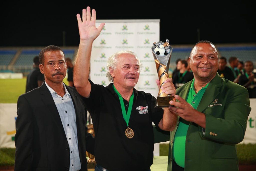 Zoran Vranes, centre, is presented with the 2014 First Citizens Cup Coach of the Tournament award from Warren Sookdar, First Citizens Chief Information Officer, right, and then TT Pro League CEO Dexter Skeene on Oct. 31, 2014 after leading Central FC to the title defence.