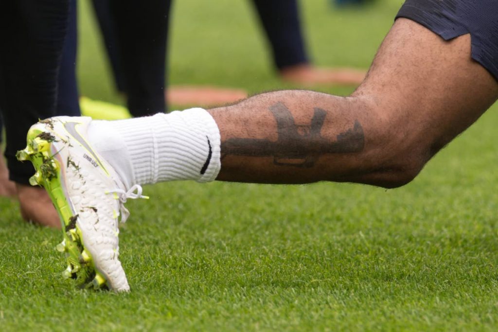 England's midfielder Raheem Sterling displays a tattoo of an assault rifle on his lower leg during a training session at St George's Park in Burton-on-Trent last Monday, ahead of their international friendly football matches against Nigeria and Costa Rica. AFP PHOTO