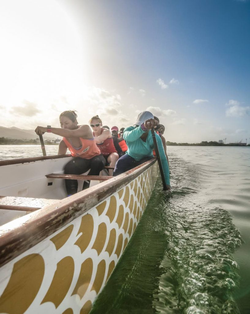 Members of Aquaholics Dragon Boat Club train yesterday in Cocorite.
PHOTO BY JEFF MAYERS