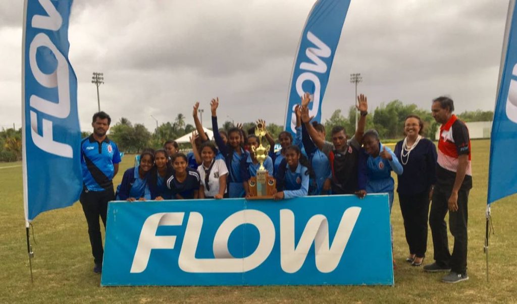 Barrackpore East players and coaching staff celebrate with Cindy-Ann Gatt, director of marketing at Flow, second from right, and SSCL members.