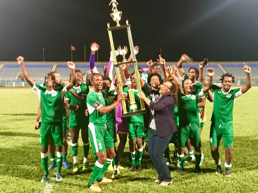 W Connection captain Gerard Williams, front left, collects the Charity Shield 2018 trophy from TT Pro League CEO Julia Baptiste, as his teammates celebrate their win over North East Stars on Friday at Ato Boldon Stadium in Couva.