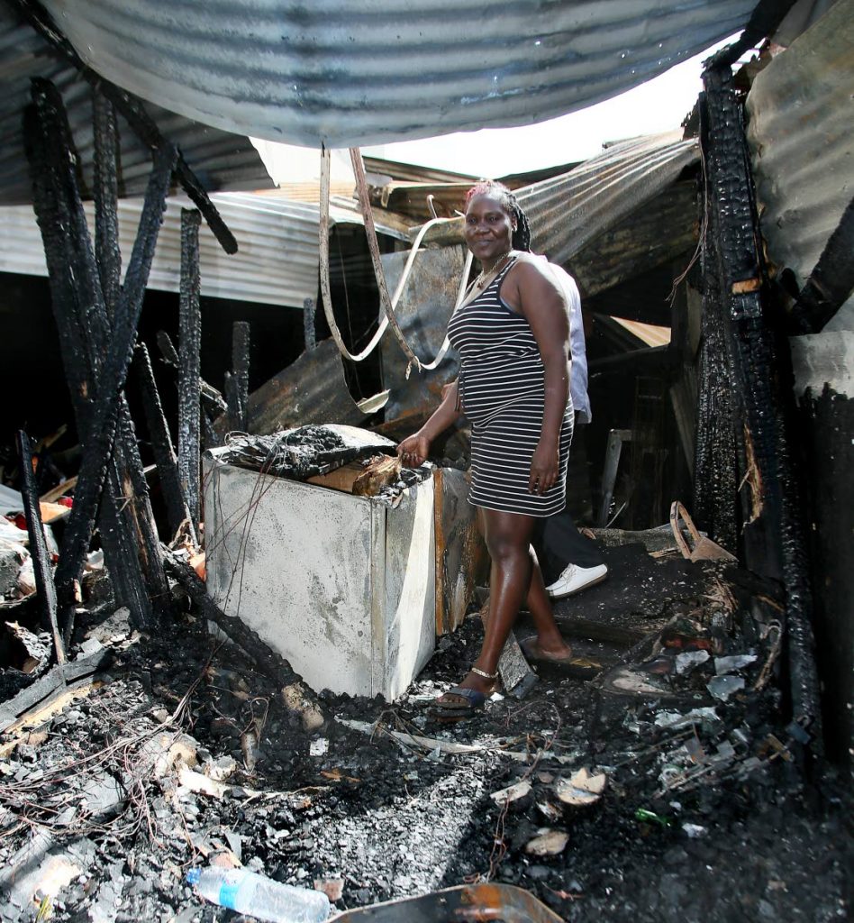 Carla Bernard owner of Carla’s Delight shows her hut at the Drag Mall Henry street PoS which was gutted by fire.