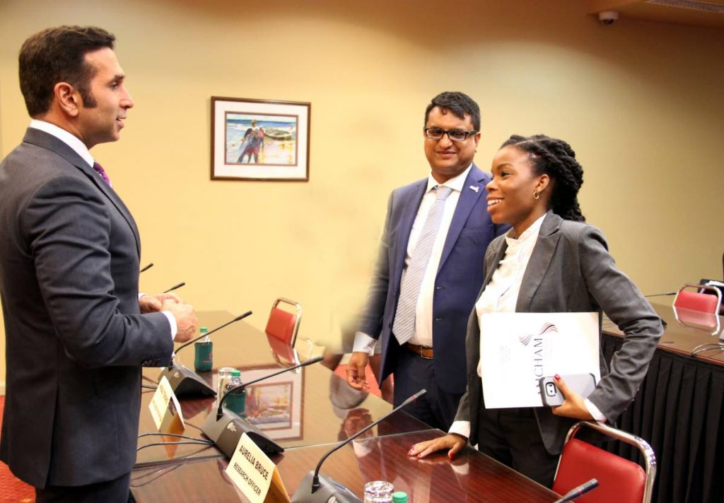MEETING OF MINDS: Attorney General Faris Al-Rawi speaks with Amcham TT’s CEO Nirad Tewarie and research officer Aurelia Bruce at yesterday’s sitting of the JSC on the Cybercrime Bill at the Parliament 
yesterday.    PHOTO BY SUREASH CHOLAI