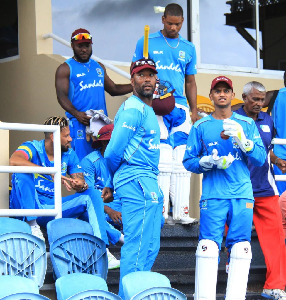 West Indies players take a break after a training session at the Queen’s Park Oval, Port of Spain, yesterday. The WI will face Sri Lanka in the first of a three-match Test series, which starts tomorrow.